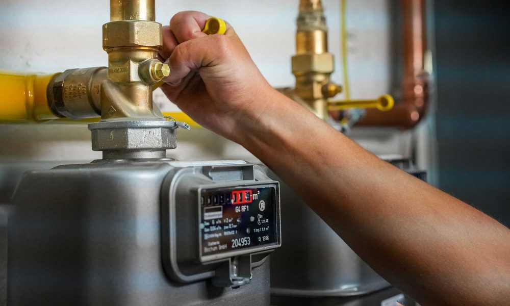 person adjusting a gas meter to reduce gas usage